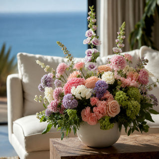 True bloom white and purple hollyhock stems mixed with other florals in a luxury floral arrangement; works beautifully in spring, summer, and fall because the saturated fuchsia blooms create focal contrast while softer florals balance the overall design.