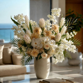 White Protea Stem Styled in an arrangement with a tropical inspired theme. styled in a vase on a marble coffee table in a luxury modern coastal home with ocean views