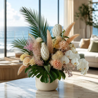 White flocked king protea stem styled in a sculptural faux floral arrangement in a tall ceramic vase with ivory and neutral botanicals in a refined modern interior