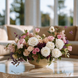 Luxury faux floral centerpiece with blush pink blooms, white duchess roses, and romantic garden-inspired stems styled in a sculptural cream bowl vase by True Bloom Floral