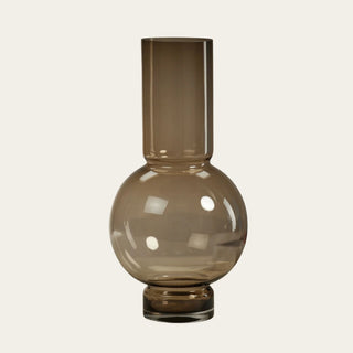Taupe Monceau Glass Vase with rounded glass base and tall neck, ideal for styling faux roses, tulips, hydrangeas, peonies, greenery, blossoming branches, and year-round floral arrangements.