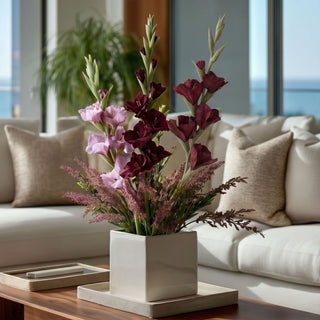 Burgundy True Bloom real touch gladiolus stems styled in a modern white vase on a wood coffee table in a neutral living room with layered faux florals
