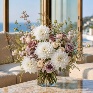 Luxury faux white dahlia floral arrangement with soft mauve roses and airy greenery in a clear glass vase, styled in a bright California coastal living room by True Bloom Floral.