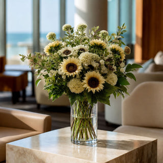Dried Creamy White Sunflower Bundle styled in a white vase with greenery and neutral florals, creating a sophisticated year-round arrangement that works beautifully in spring, summer, fall, and winter decorating.