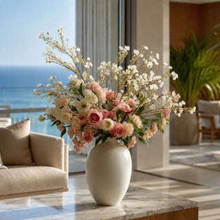 White Faux Chamelaucium stems styled with roses and soft florals in a neutral vase, creating an airy arrangement filled with movement, texture, and elegant year-round styling perfect for modern transitional homes.