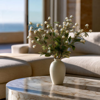 White Globe Amaranth Spray stems styled in a white vase in a modern transitional home, adding airy texture, movement, and botanical softness to a year-round floral arrangement.