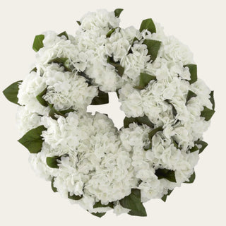 True Bloom white hydrangea wreath with full white faux blooms, green leaf accents, and a rounded 24-inch silhouette for year-round door, mantel, and interior wall styling.