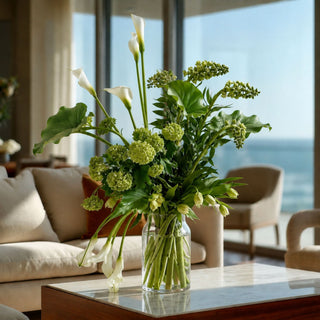 Green faux calla leaf — artificial calla leaf styled in a glass vase for a year-round faux greenery display.