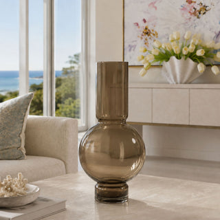 Faux floral vase styled with artificial flowers and silk greenery on a marble table in a bright modern living room for year-round home decor.