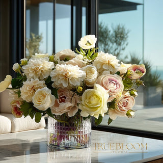 Luxury faux white and ivory roses floral arrangement in a clear glass vase on a marble surface, styled in a bright coastal home with ocean views and soft natural sunlight, elegant high-end home decor