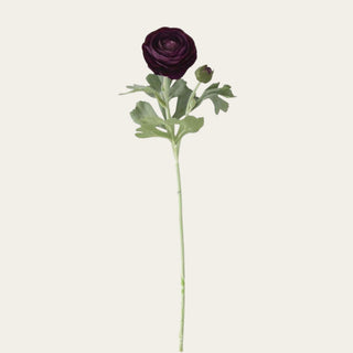 Single true bloom real touch dark purple rose with green leaves on a light beige background