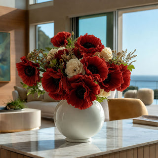 Dark orange real touch poppy arrangement styled in a ribbed brown vase, featuring burnt poppy blooms with dark centers, cream accent flowers, soft greenery, and dried floral texture on a wood table in a warm interior setting.