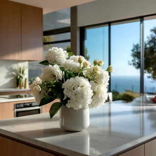 White real touch hydrangea 6-stem bundle styled in a white vase on a modern kitchen island, creating a fresh year-round faux floral arrangement that works beautifully with spring greenery, summer neutrals, fall warm tones, and winter or holiday styling.
