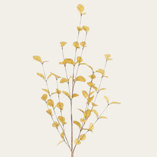 Close-up of yellow eucalyptus fabric leaves showing the soft matte texture, delicate veining, and airy faux branch detail that gives the stem its sculptural look.