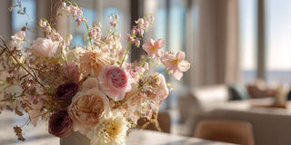 Soft pink, roses and burgundy florals in a lush floral arrangement for true bloom floral with afternoon sun shining in