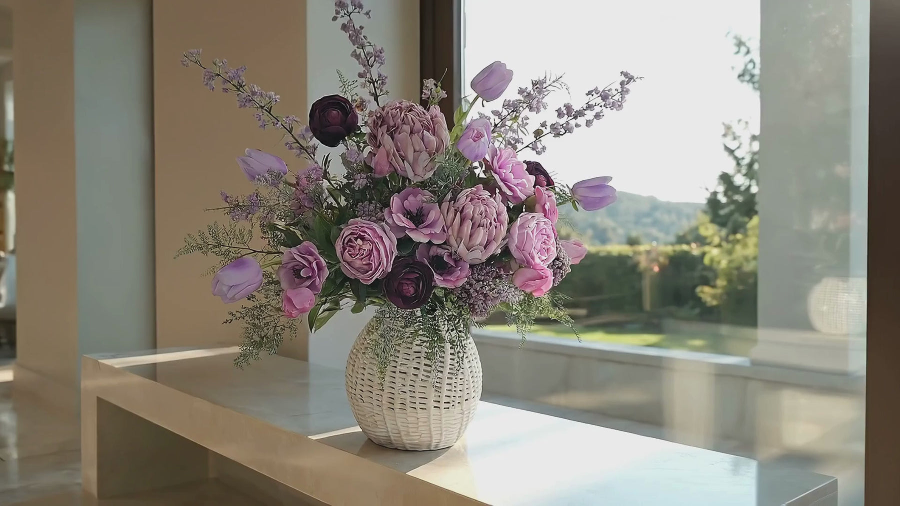Luxury faux pink peony and plum rose bouquet in a textured white vase on a marble countertop, softly lit by natural window light with a blurred outdoor garden view, elegant high-end home decor floral arrangement video