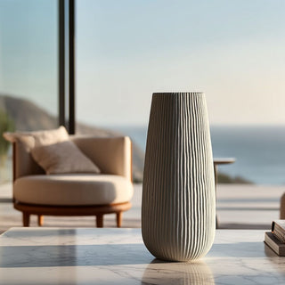 Decorative medium sized vase on a table with a scenic view of mountains and sea in the background