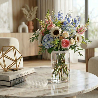 Clear Vase Buddy floral grid used to create a balanced faux flower arrangement in a glass cylinder vase with hydrangeas, roses, and greenery on a styled coffee table