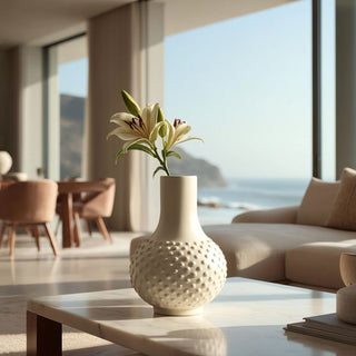 Narrow opening vase for flower arranging with single stem lily, demonstrating how vase opening size affects floral styling in a modern home